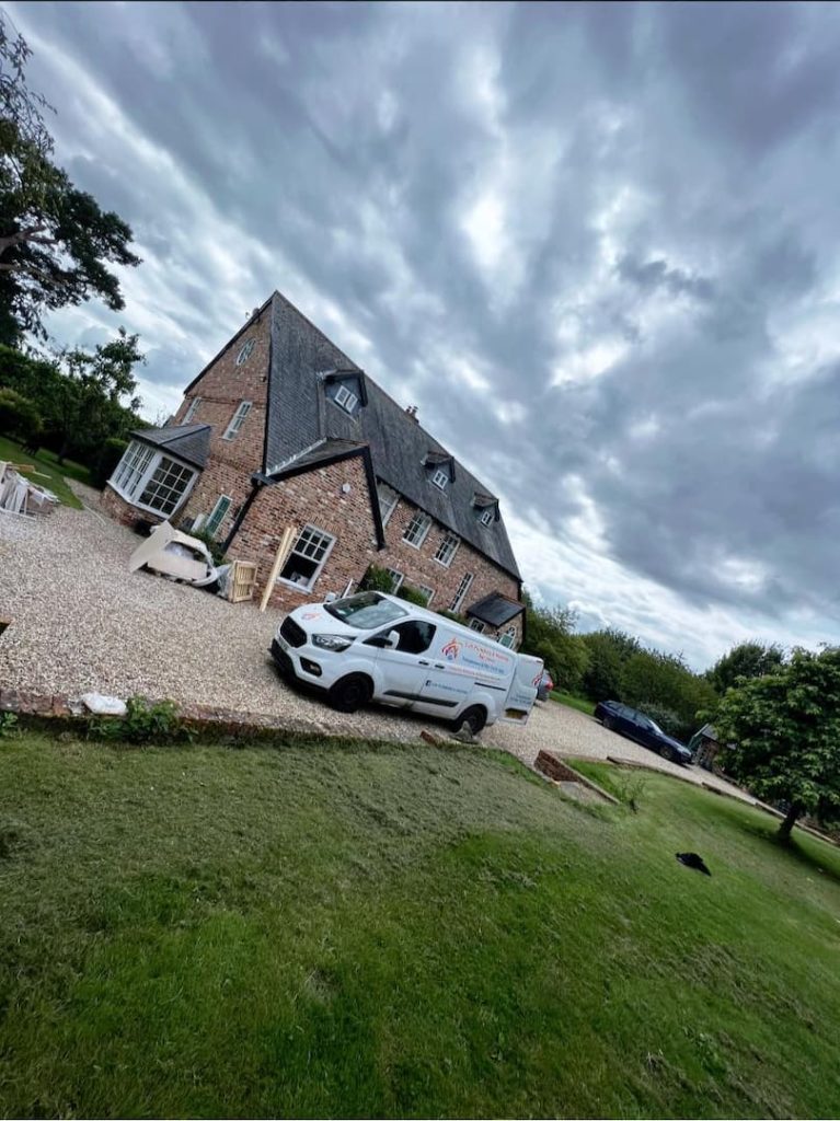 CJS Plumbing van parked outside customers house